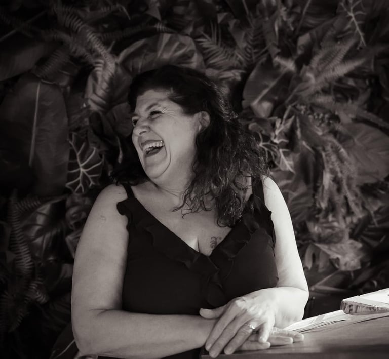 a woman in a black dress is laughing and laughing