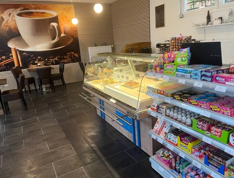 a coffee shop with a large cup of coffee and a cup of coffee