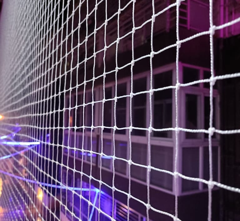 Close-up of a freshly installed pigeon net stretched tightly across a balcony.