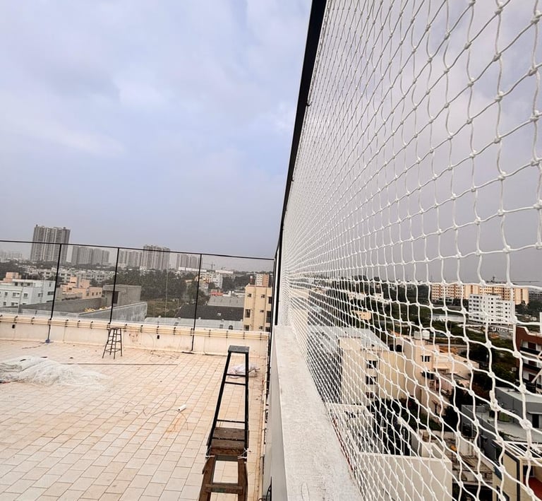 Pigeon netting installed on a rooftop, blending seamlessly with the surroundings.