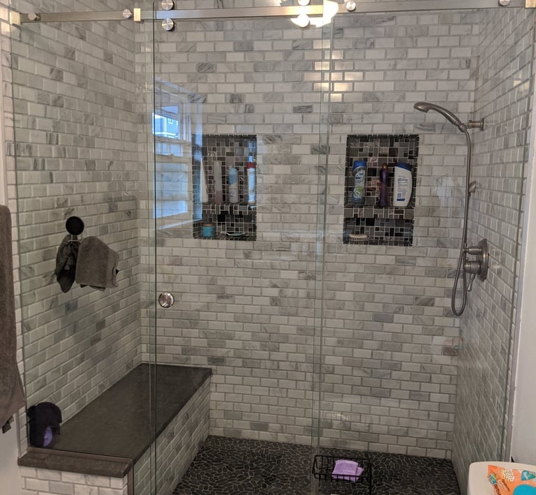 subway tile with 2 shampoo niches.