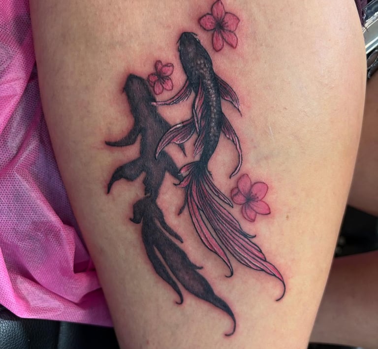 a tattoo of a coi fish and a woman's legs