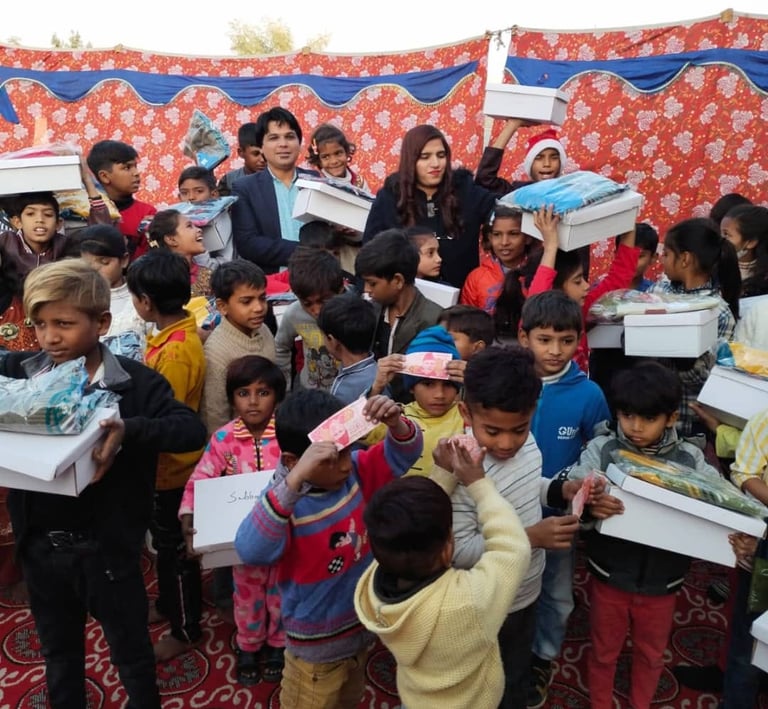 A group of children receiving gift boxes and donations during a charity event for humanitarian aid.