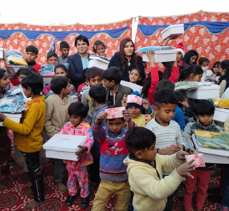 Volunteers distributing charity donation boxes and clothes to underprivileged children at a community event.