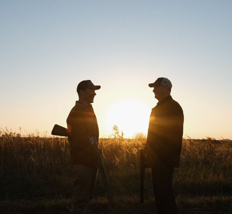 two hunters taking at sunrise