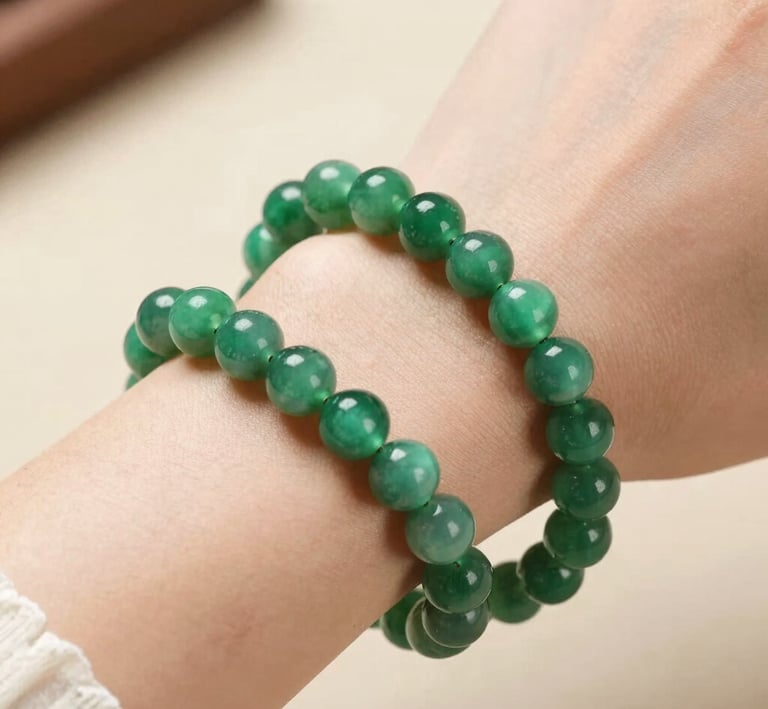 A selection of colorful gemstones laid out on a wooden table.