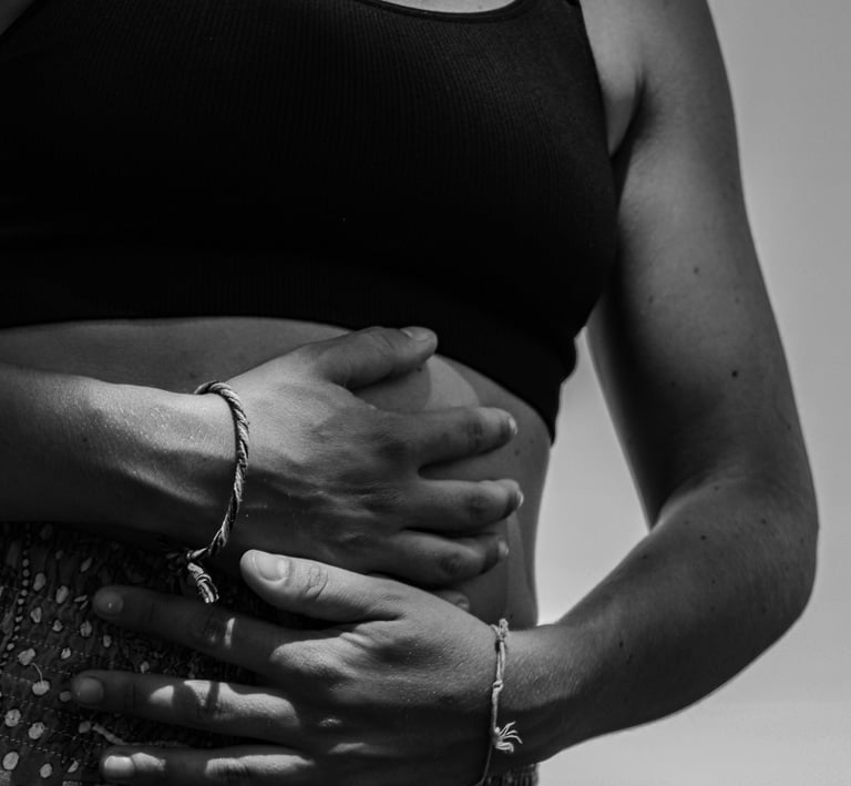 a woman in a black and white photo of her belly
