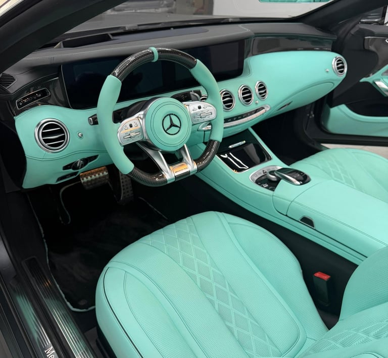 Custom Mercedes-Benz interior featuring Tiffany blue leather seats and matching mint dashboard accents.