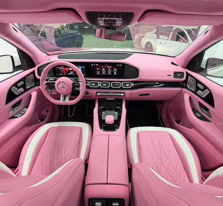 Custom pink leather Mercedes interior with matching steering wheel and dashboard.