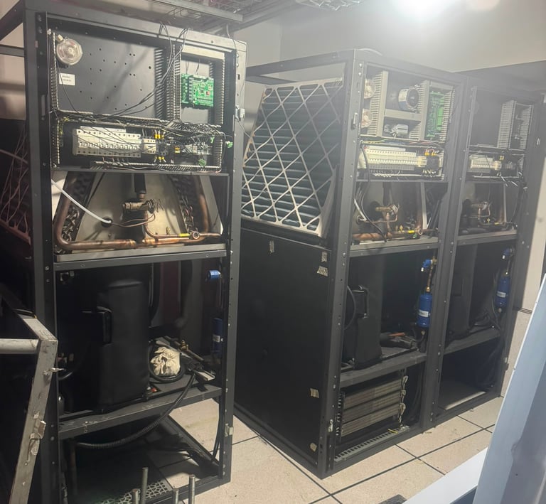 Industrial HVAC precision cooling units with exposed wiring and internal components in a data center server room.