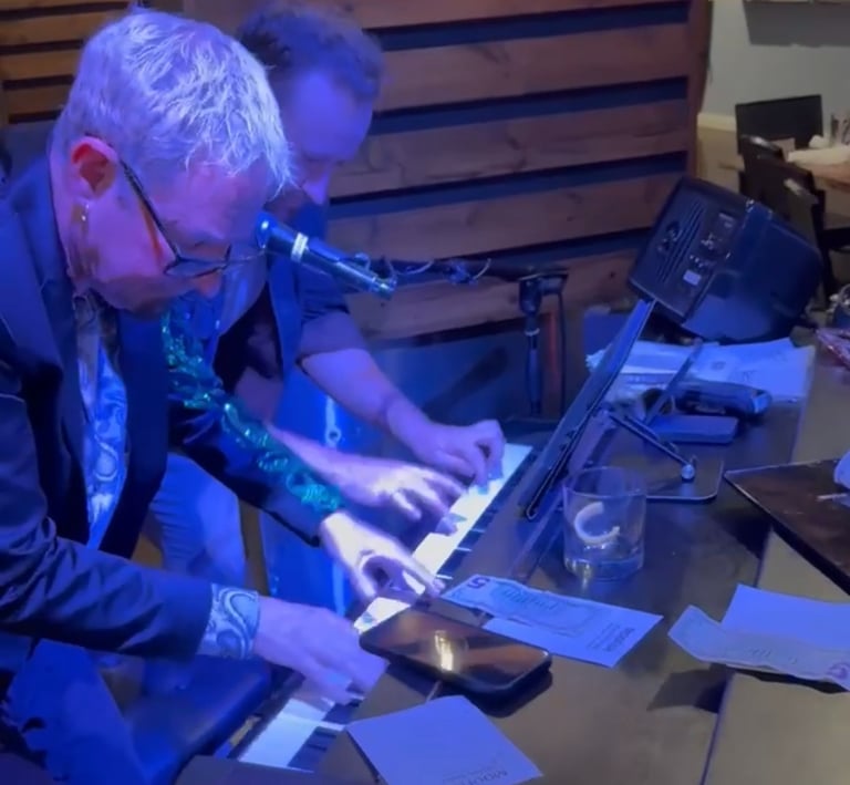 Dave Coldren and a fellow performer play a private party