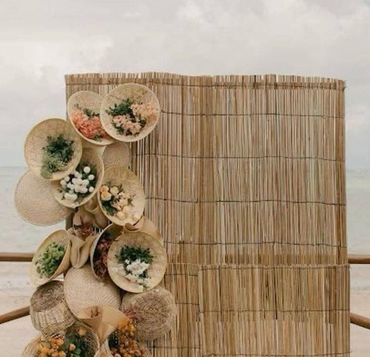 a wooden fence with a bunch of flowers on it