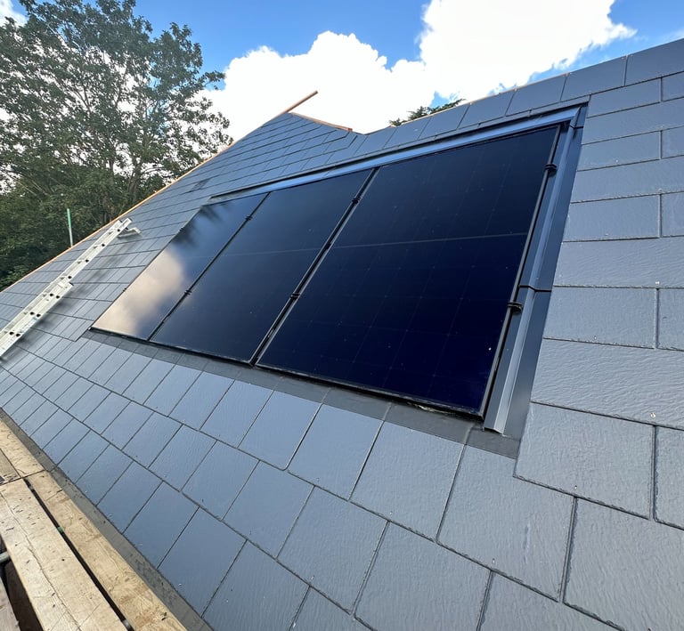 Black solar panels installed on a grey slate roof for residential renewable energy in Milton Keynes.