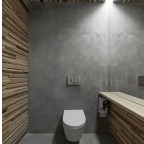 Modern minimalist bathroom featuring a wall-hung toilet, concrete walls, and wood slat accents.