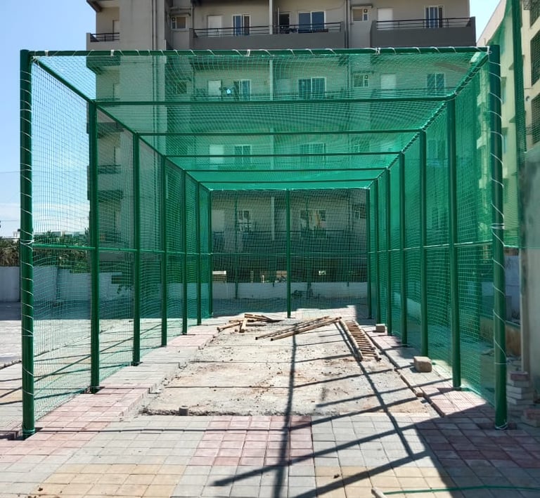 Technician securing a pigeon net frame on a window, ensuring durability and safety.