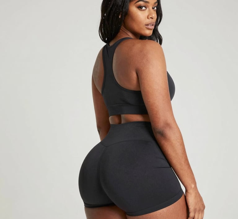 A close-up of a client’s determined face mid-rep, sweat glistening, embodying dedication and progress.