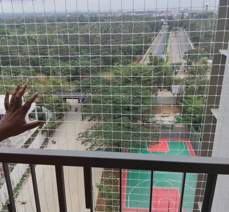 A child playing safely behind a securely installed balcony net.
