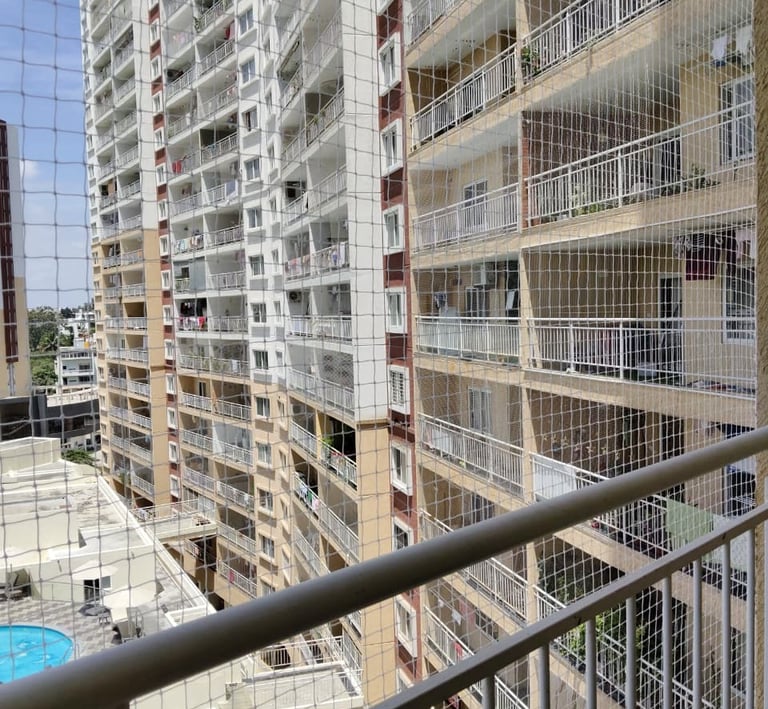 Apartment balcony secured with pigeon net in Pune to maintain cleanliness and hygiene.