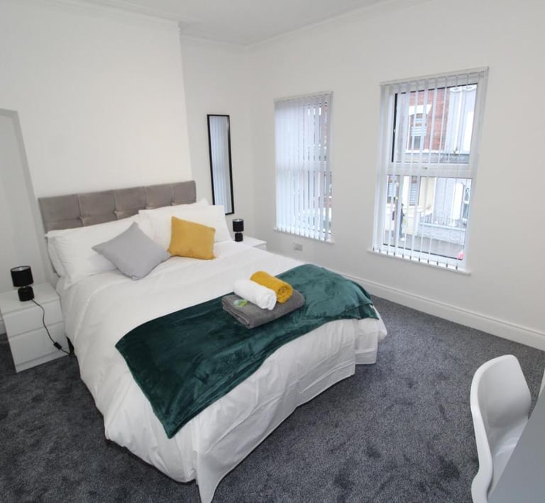 bedroom with bed and white walls