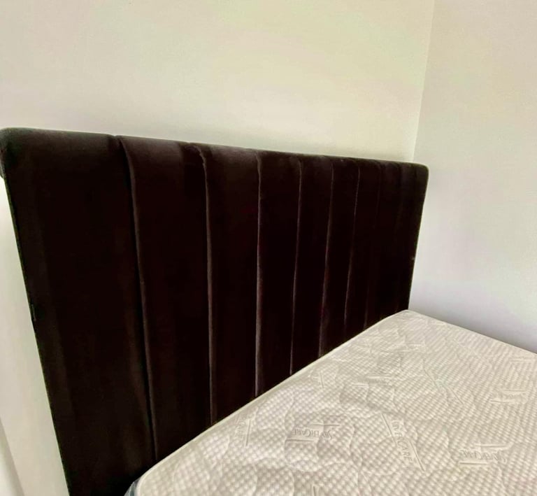 A modern dark grey velvet channel-tufted headboard paired with a SilverCare quilted mattress.