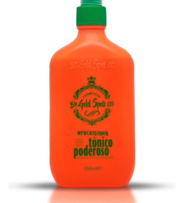 Orange bottle of Gold Spell Co Tônico Poderoso hair growth tonic with a green spray nozzle.