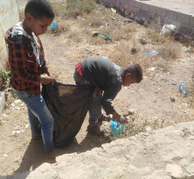 Muhamasheen boys clean up garbage