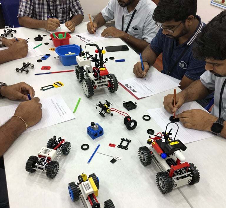 Group of kids proudly displaying their finished robotics projects, smiling against the backdrop of a modern classroom.