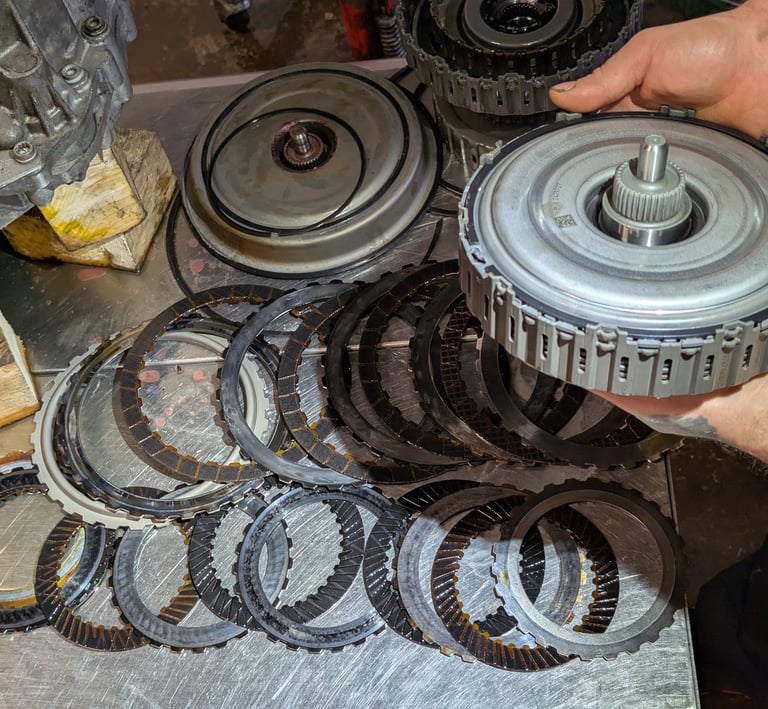 A mechanic holding a failed Audi S3 DSG Clutch Pack