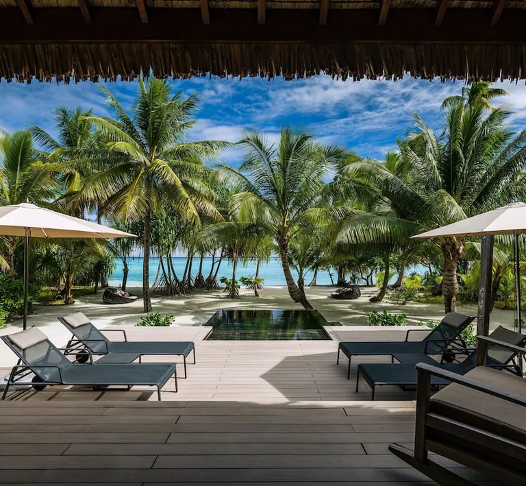he Brando:  A serene private villa emerges amidst swaying palm trees on a pristine, white-sand beach