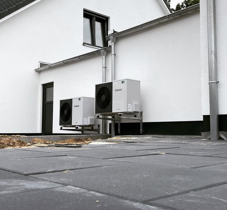 a white refrigerator and a refrigerator in front of a house