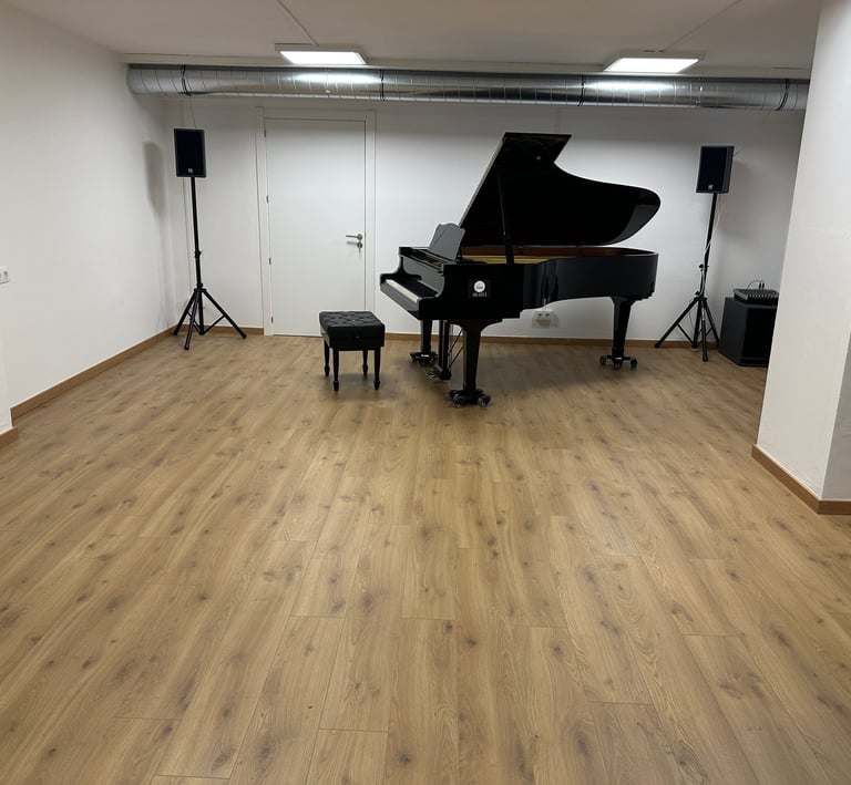 a piano player is in a big room with wood floor