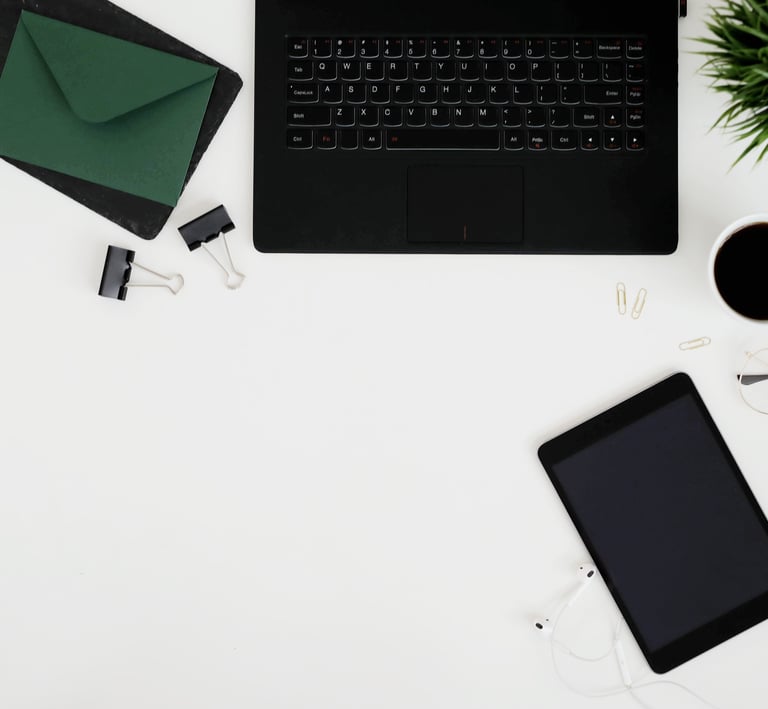 a laptop computer and a tablet on a desk
