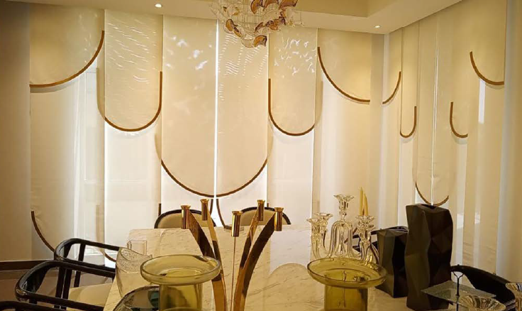 a table with a glass table top and chairs and beautiful Curtains