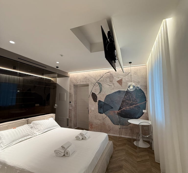 a bedroom with a bed and a television