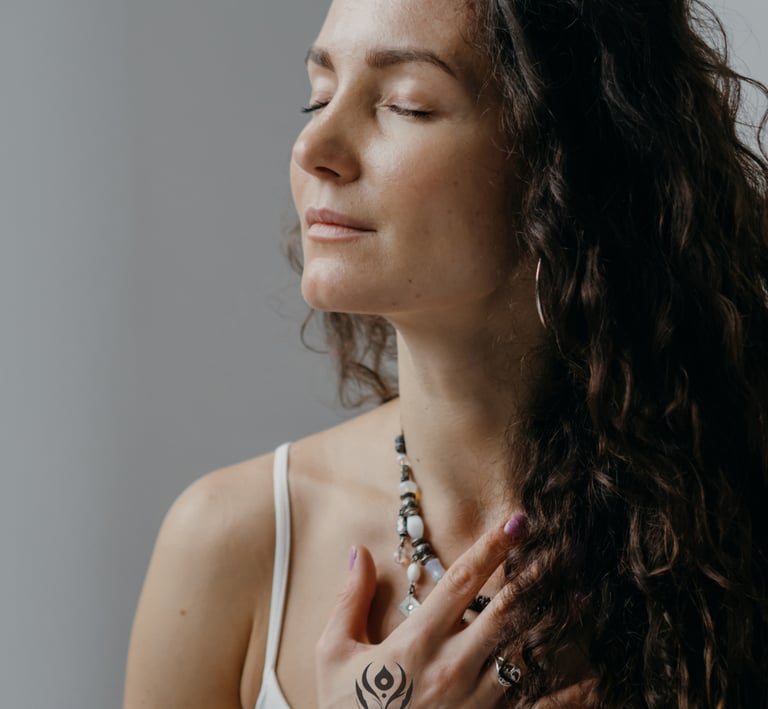 woman holding hand on chest