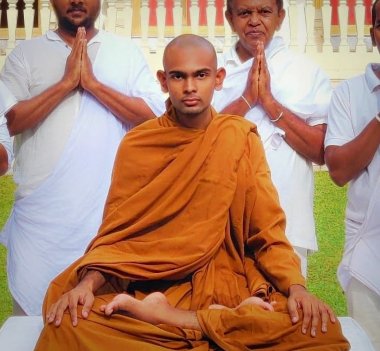 a man in a monk robe sitting in a meditation position