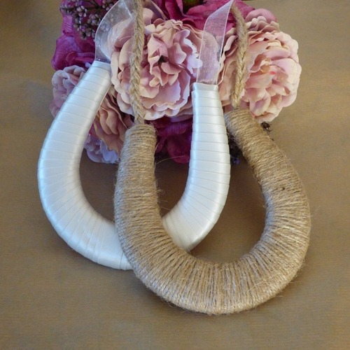 a bouquet of flowers and a our ribbon and twine horseshoes
