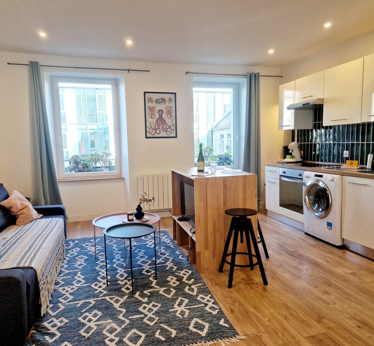 a living room with a couch and a kitchen