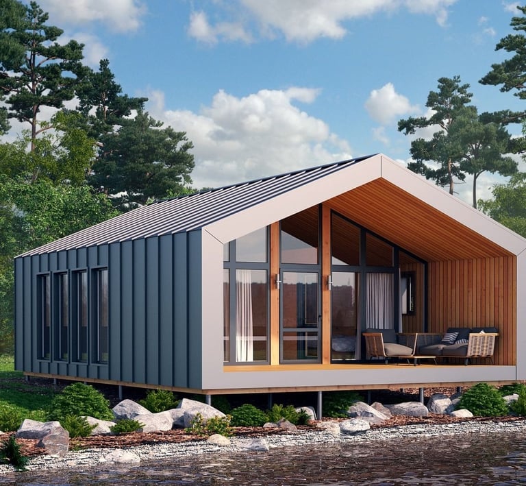 Modern prefabricated barnhouse cabin with a metal roof and glass facade on a lake shore.