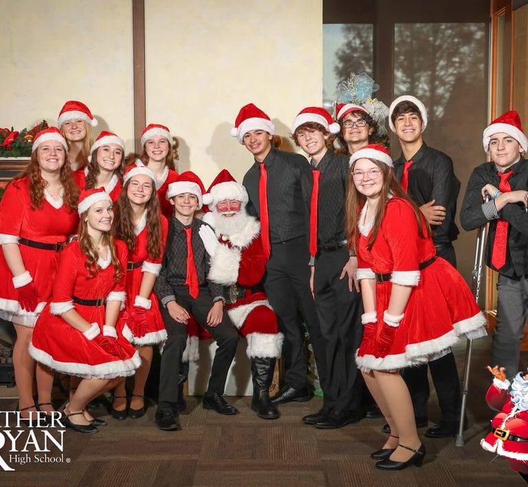 Santa Jay with a group of young people in Christmas garb.