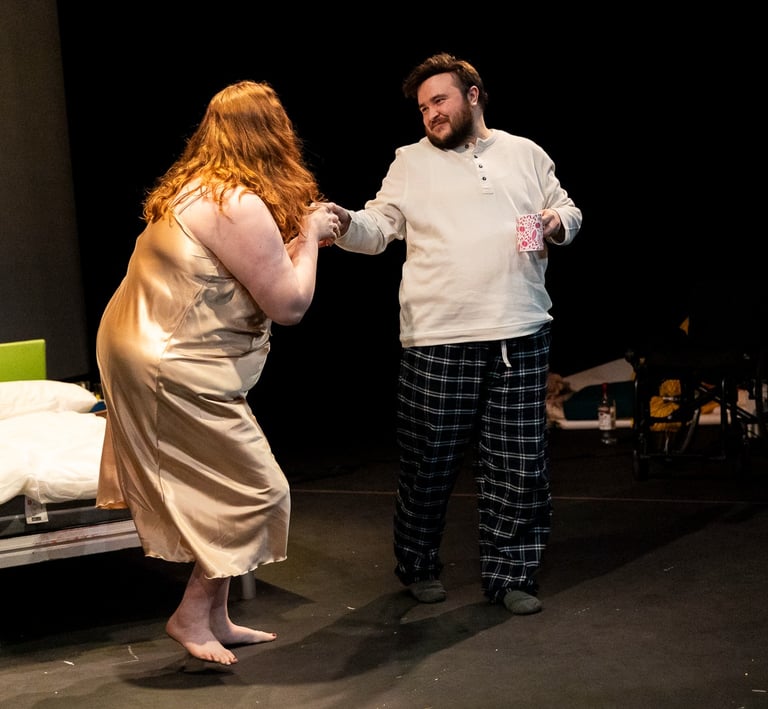 A white man and woman dancing tenderly in nightwear
