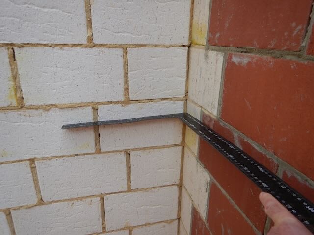 Professional inspector performing AS 4349.1-compliant building inspection Perth, reviewing foundations and brickwork.