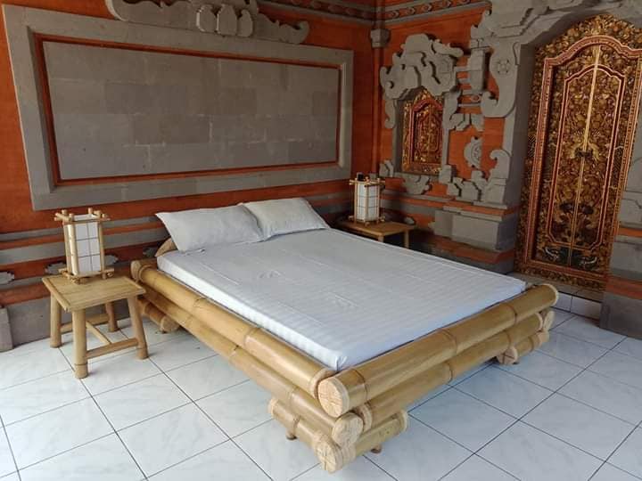 a bed with a wooden bed frame and a white bed