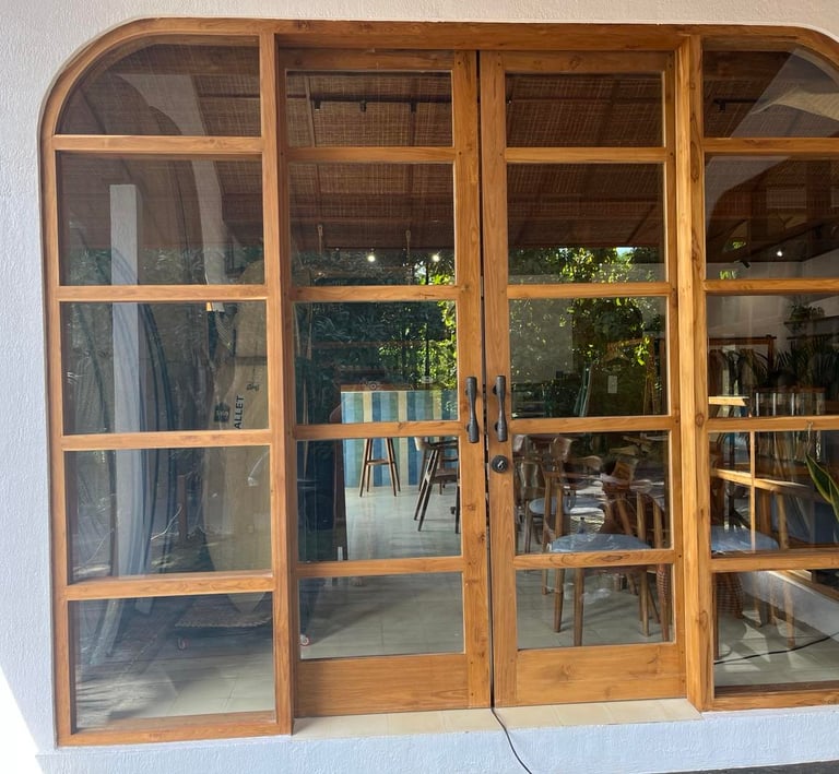 a large open door with a table and chairs