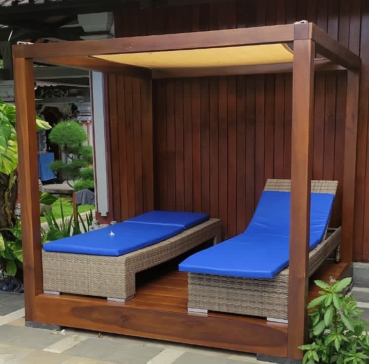 a couple of lounge chairs sitting next to a pool