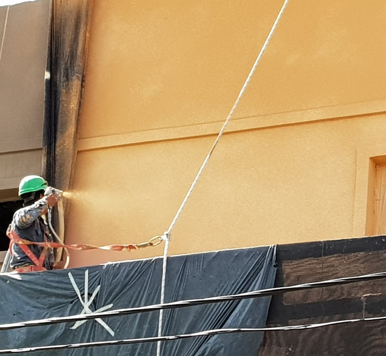 Aplicación de revestimiento acrílico proyectado en fachada