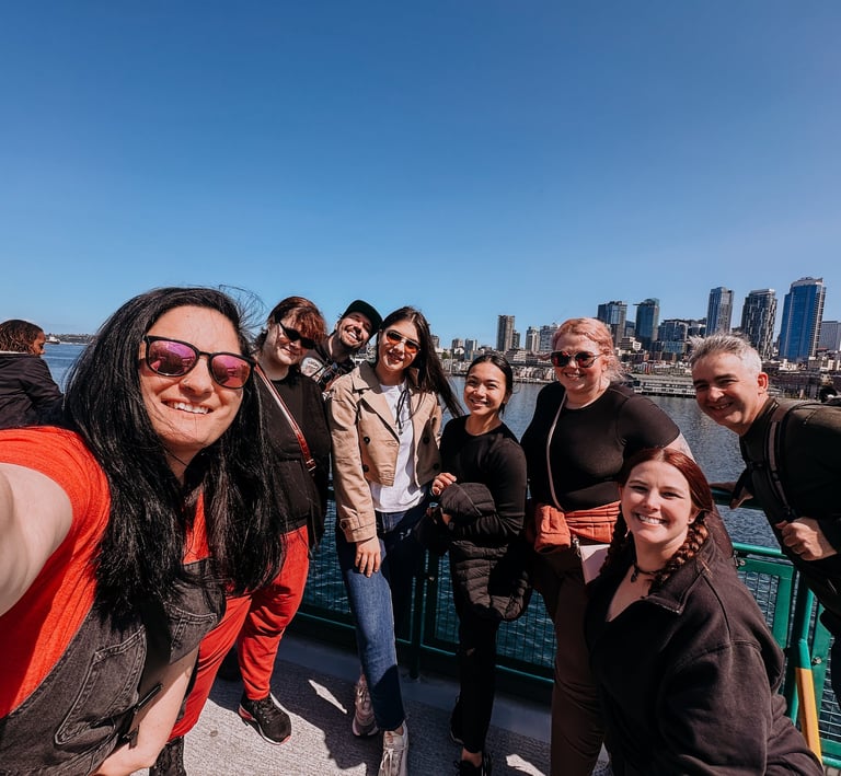 team on the ferry to Bainbridge Island with the Seattle skyline in the background during a team retr