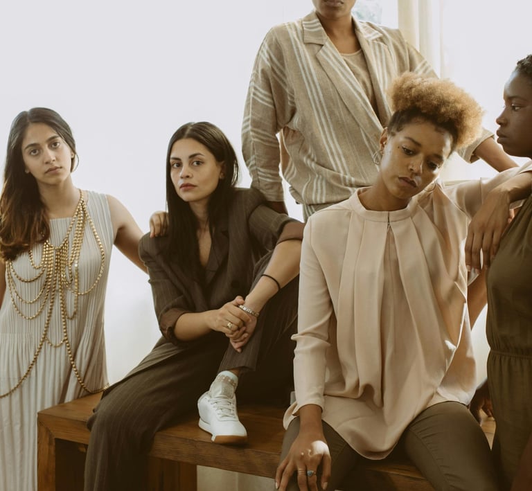 Diverse group of women posing together in neutral fashion.
