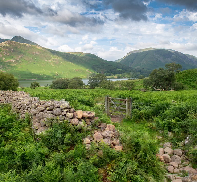 a stone wall with a stone wall and a gate ©Mick Howard