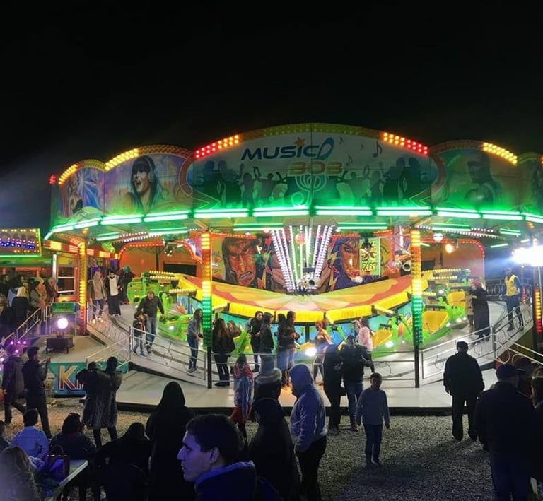 Agadir carnival ride at night time with people walking around